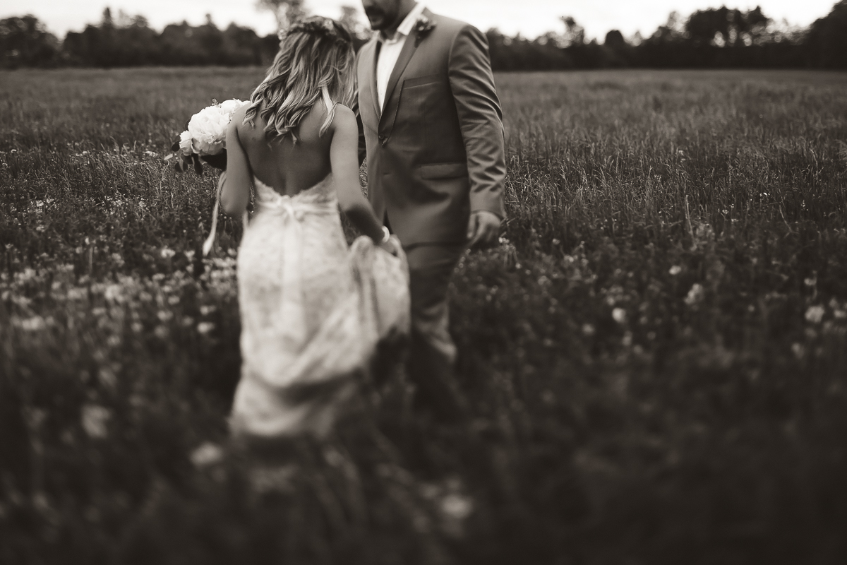 bride and groom in feild 