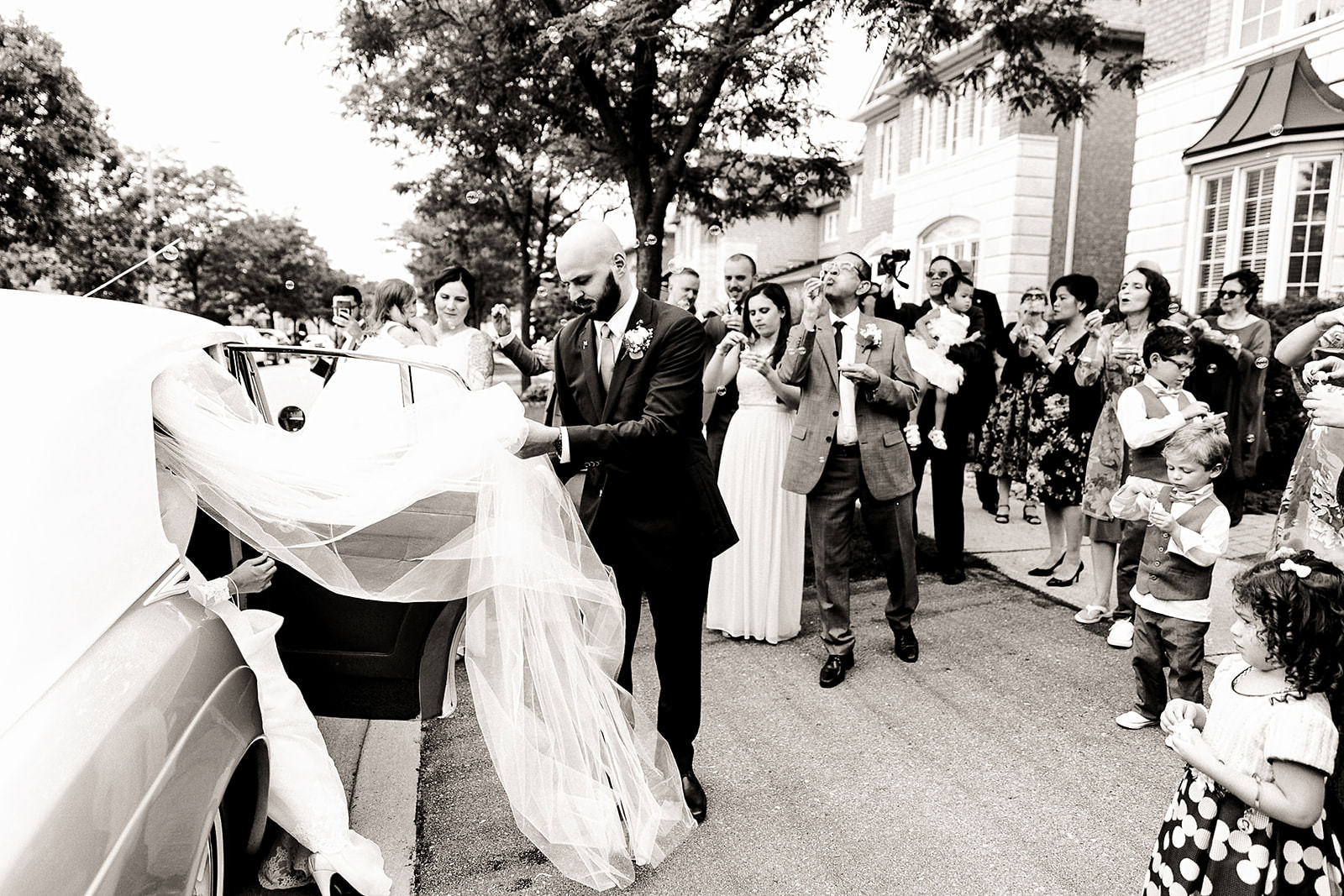 Couple getting into wedding car